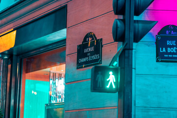 Champ élysées boulevard sign view during night with traffic lights.