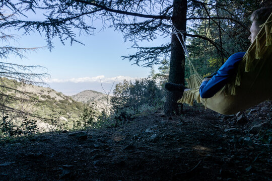 hiker relaxe in a hammock at madari trail in cyprus