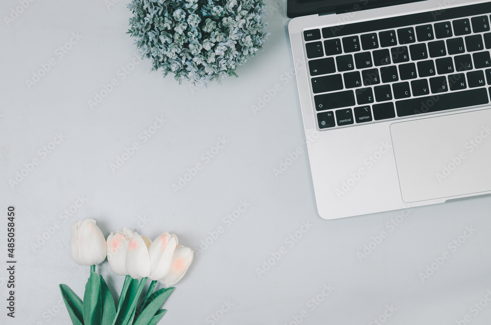 Poster computer laptop and flower on desk.flat lay with copy space.