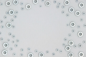 Frame made with metal hexagon nuts on gray background. Abstract border. Top view Flat lay Copy space