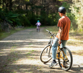 happy teen boy riding a bike on natural background, forest or park. healthy lifestyle, family day out