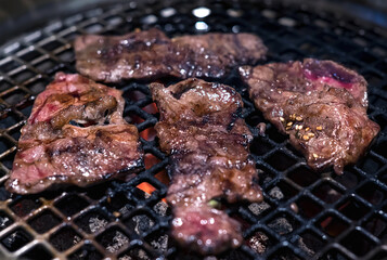 Raw beef slice on grille for barbecue or Japanese style yakiniku