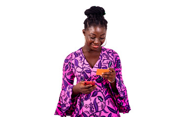 beautiful young businesswoman using credit card and mobile phone smiling.