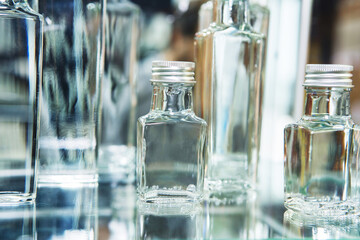 Glass bottles with metal stoppers. Small containers for bottling alcoholic beverages. selective focus