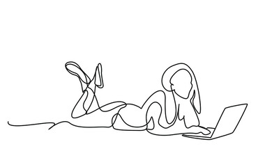 happy beautiful woman using laptop lying on floor