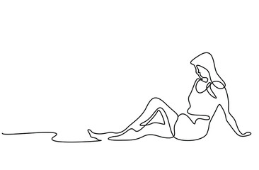 Beautiful woman sitting on the floor and posing. woman going on vacation stretching and posing on the beach .