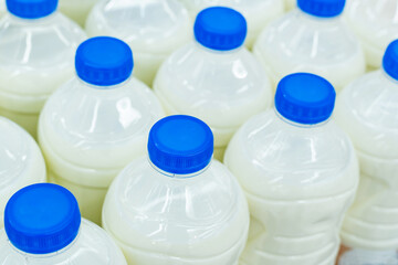 Milk in plastic bottles. Trade in dairy products wholesale and retail. Close-up