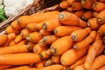 Carrots in a farm shop window. Sale of ripe vegetables wholesale and retail. Close-up