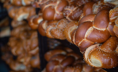 Fresh crispy delicious bread in form of braid lies on open stall of market. Bread is very famous product in different countries. Since ancient times people have learned to bake bread. Close-up.