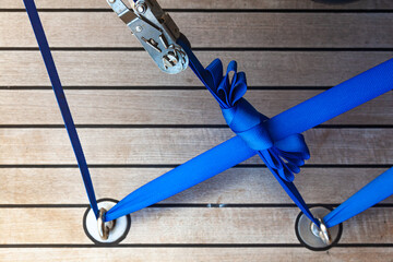 Cargo straps are attached to the deck of the yacht with a ratchet lock.