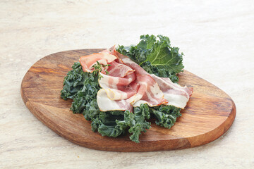 Raw pork bacon over board