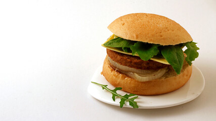 Vegan burger. Meat based on soy and wheat proteins. Cheese based on coconut oil.