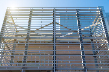 The exterior interior building in the form of a metal contruction against a blue sky background.