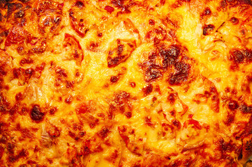 Pizza background with a lot of cheese close-up, top view.