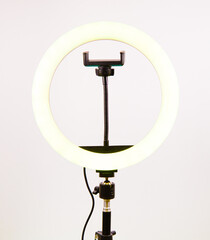 Round lamp with a smartphone holder. Yellow light.