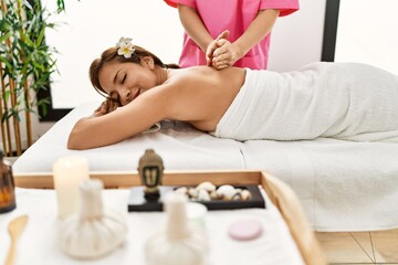 Obraz na płótnie Canvas Young latin woman having back massage session