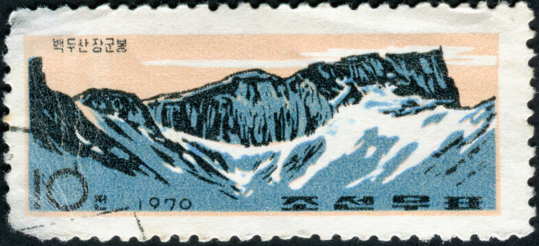 NORTH KOREA - CIRCA 1970: Postage stamp printed in North Korea shows landscape with mountains