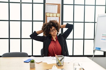 Young african american woman tired with hands on head working at office