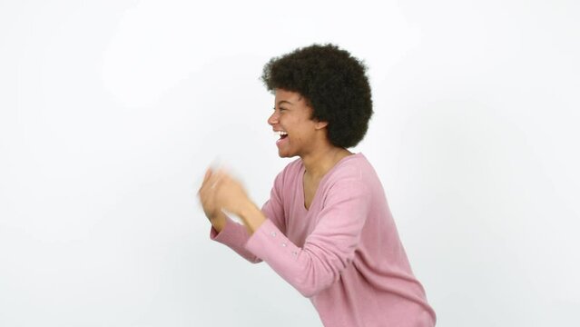 Young African American woman celebrating a victory over isolated background