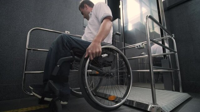 Special elevator for the person with a physical disabilities. A man in a wheelchair uses a special elevator