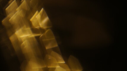 Golden bokeh crystal abstract light rays background, shiny flare texture photo overlay optical lens...