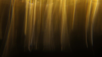 Golden bokeh crystal abstract light rays background, shiny flare texture photo overlay optical lens...