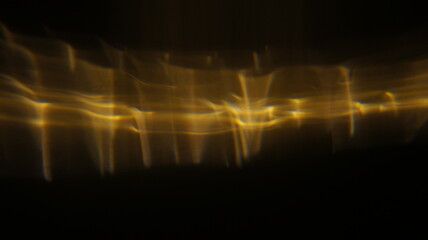 Golden bokeh crystal abstract light rays background, shiny flare texture photo overlay optical lens...