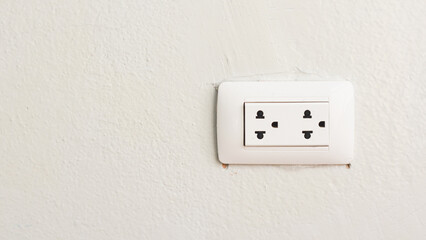 white power socket on cement wall