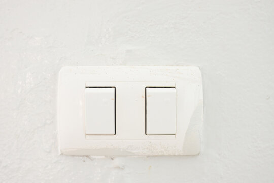 close-up photo of a light switch on-off white