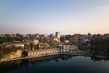 Aerial view over the city of Trezzo sull'Adda with the hydroelectric power plant in the foreground with the castle behind it.