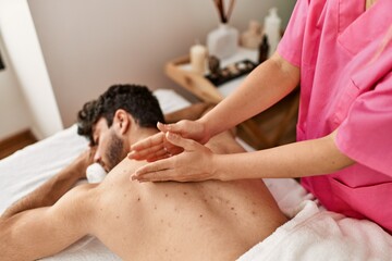Fototapeta na wymiar Man relaxed reciving back massage at beauty center.