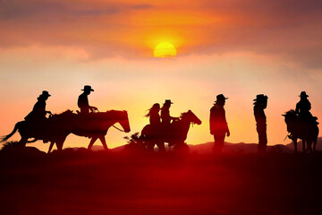 Fototapeta na wymiar The silhouette of a cowboy riding a horse at sunset on the mountain