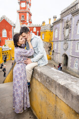 Young beautiful couple walking near National Palace of Pena in Portugal