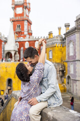 Obraz premium Young beautiful couple walking near National Palace of Pena in Portugal