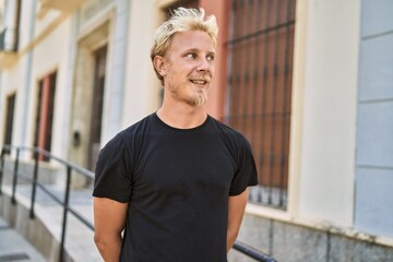 Young caucasian man smiling confident at street