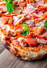 flatbread Pepperoni roman Pizza with Mozzarella cheese, chicken, ham, Tomato sauce, pepper, Spices. Italian pizza on wooden background