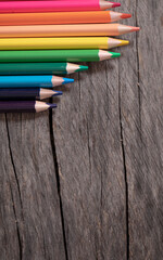 pencils on wooden background