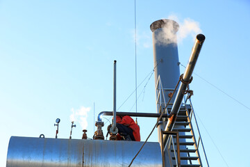 Workers are welding steam transmission pipes in a biogas power plant, North China