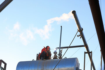 Workers are welding steam transmission pipes in a biogas power plant, North China