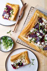 Beetroot and feta filo pizza. Beet Tart with feta, caramelized onion, pine nuts, sunflower micro greens and phyllo dough. Savoury vegetable vegetarian baking.