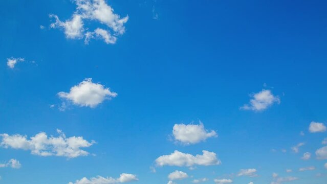 Timelapse of white clouds in blue sky. Fast moving clouds, time lapse