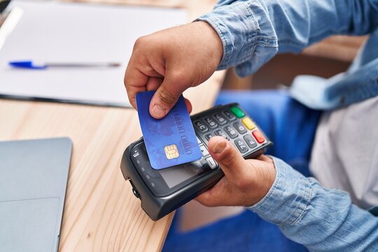 Down syndrome man ecommerce business worker using data phone and credit card at office
