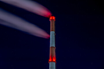 Night shots of pipes of an industrial enterprise against the background of the starry sky