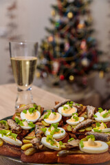 Toasted bread with sprats, eggs and herbs. Traditional Russian food for the New Year's table