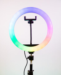 Fototapeta na wymiar Ring lamp shines in different colors. Magic of light.