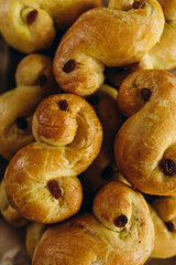 Swedish traditional buns with saffron. Freshly baked saffron buns. Baking with saffron and raisins.