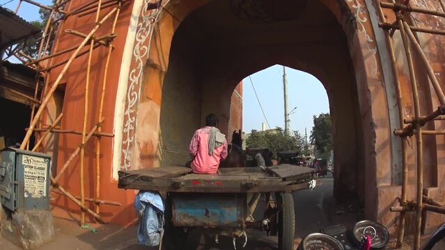 pov clip of auto rickshaw following horse carriage through the streets of Jaipur, India