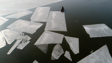 Farmers use boats to move ice on the water, North China