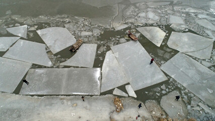 Workers use boats to push the ice over the water, North China