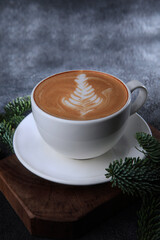 Coffee with milk in a large white cup. Drawing on the surface of a coffee drink. Vertical photo.Copy space.